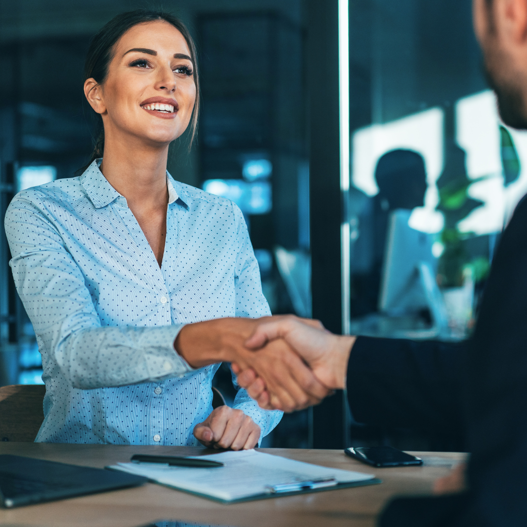 woman shaking hands with colleague