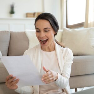 girl smiling at acceptance letter