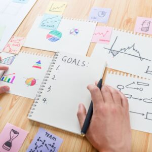 person writing out goals